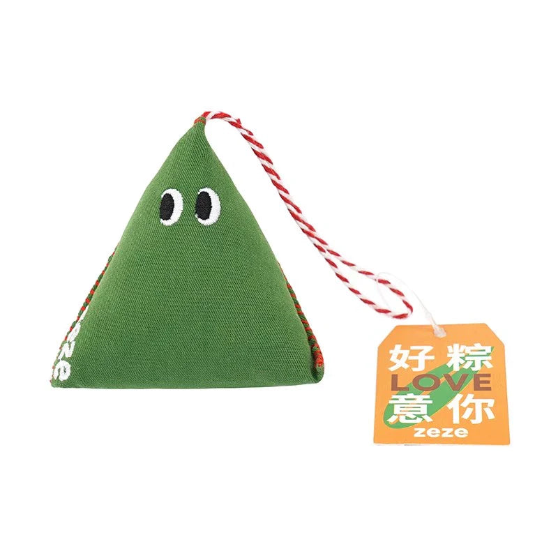 Green triangular cat toy with a face and red string, featuring a type of Chinese Dumpling - 粽子